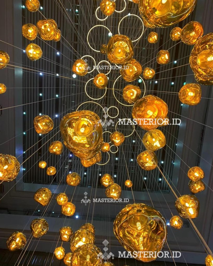 Decorative installation featuring suspended amber glass spheres with warm ambient illumination.