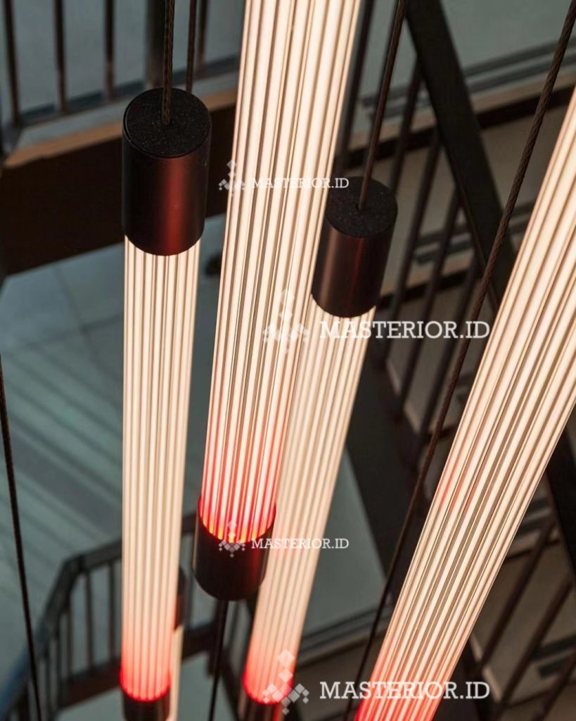Modern linear pendant lights with illuminated glass tubes and black cylindrical accents.
