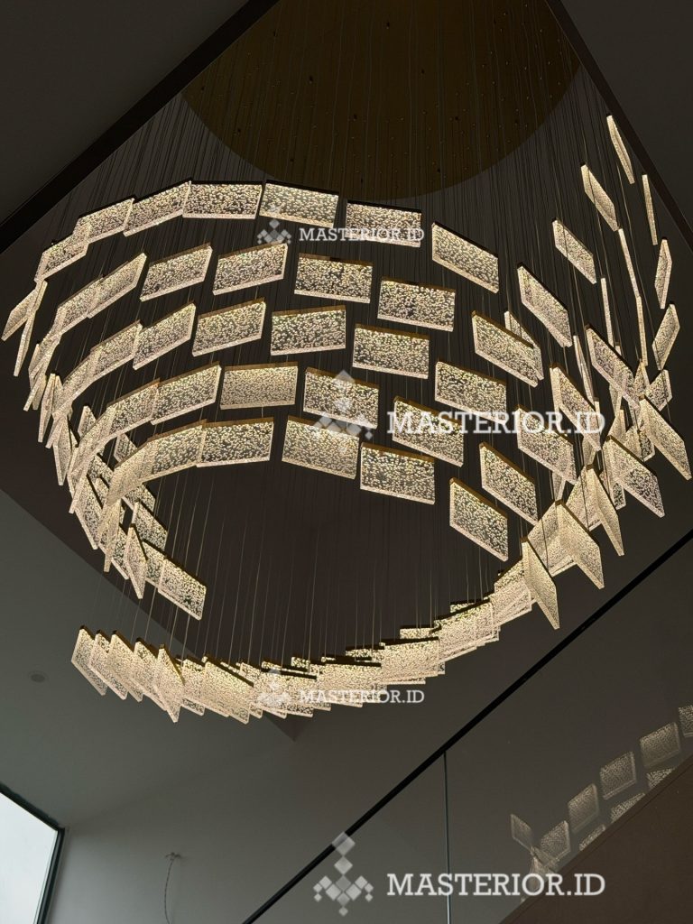 Contemporary circular chandelier with layered illuminated glass panels and brushed brass finish.